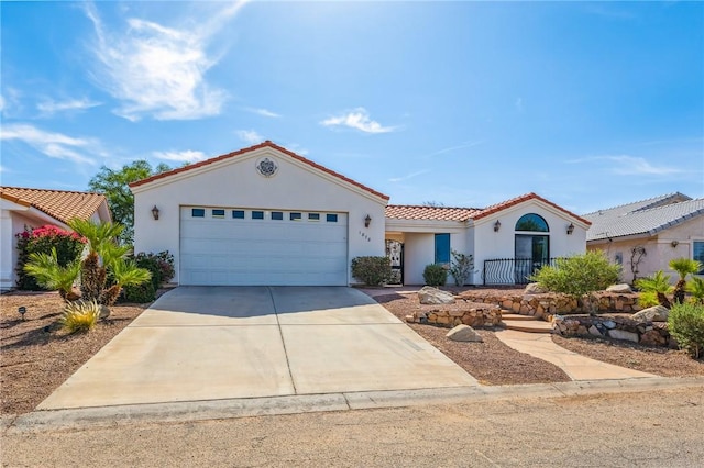 1878 E Fairway Bnd, Fort Mohave, AZ 86426 - mediterranean / spanish-style home featuring a tile roof, stucco siding, concrete driveway, and a garage