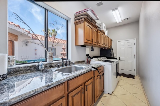 1878 E Fairway Bnd, Fort Mohave, AZ 86426 - laundry area with washing machine and clothes dryer, cabinet space, healthy amount of natural light, and light tile patterned floors