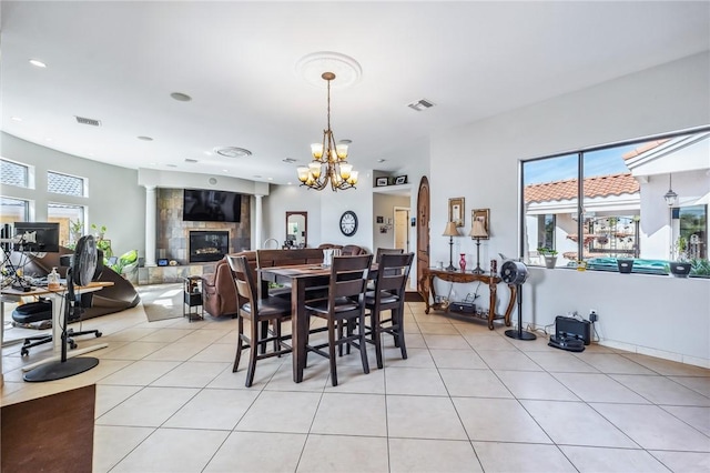 1878 E Fairway Bnd, Fort Mohave, AZ 86426 - dining area featuring a tile fireplace, light tile patterned flooring, a chandelier, plenty of natural light, and recessed lighting