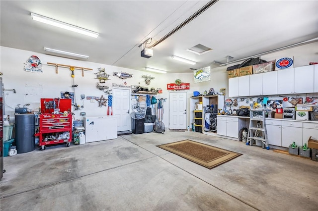 1878 E Fairway Bnd, Fort Mohave, AZ 86426 - garage with a garage door opener and a workshop area