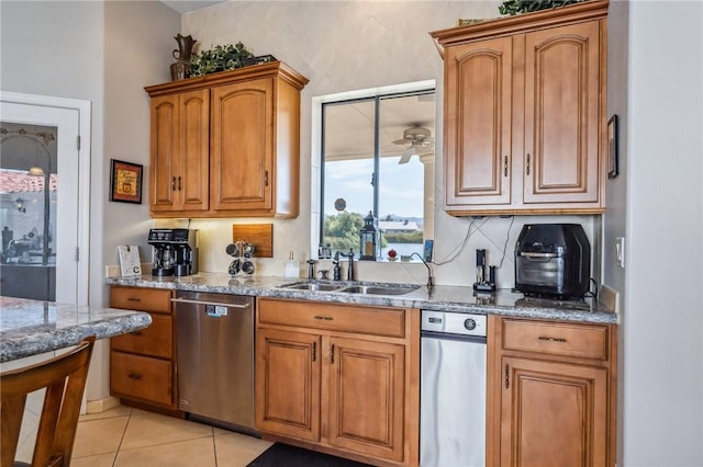 1878 E Fairway Bnd, Fort Mohave, AZ 86426 - kitchen with dishwasher, a ceiling fan, brown cabinets, stone counters, and light tile patterned floors