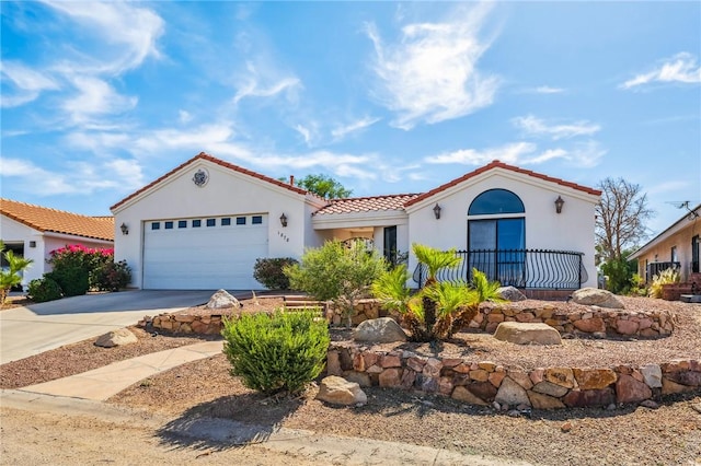 1878 E Fairway Bnd, Fort Mohave, AZ 86426 - mediterranean / spanish house with a tiled roof, concrete driveway, a garage, and stucco siding
