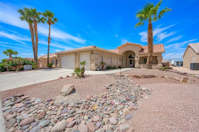 6101 S Bella Vista Dr, Fort Mohave, AZ 86426 - mediterranean / spanish home with an attached garage, stucco siding, concrete driveway, and a tile roof