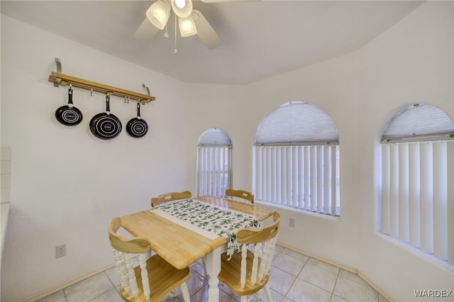 dining room with a ceiling fan and light tile patterned flooring