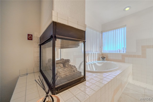bathroom with tile patterned floors and a jetted tub