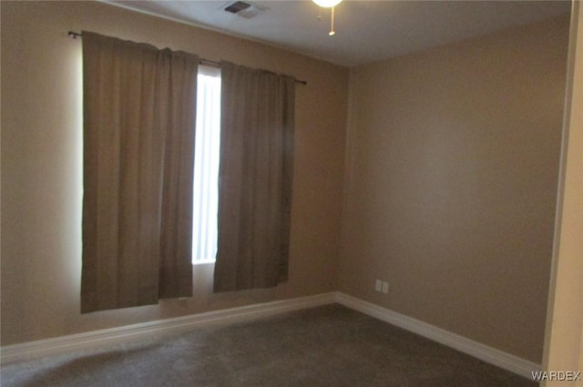 empty room featuring visible vents and baseboards