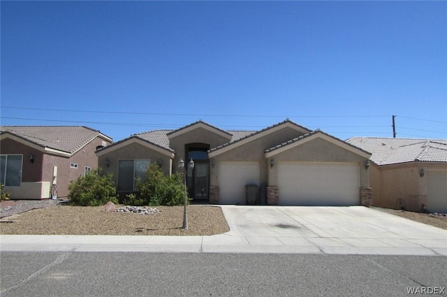 single story home featuring concrete driveway, an attached garage, a tiled roof, and stucco siding