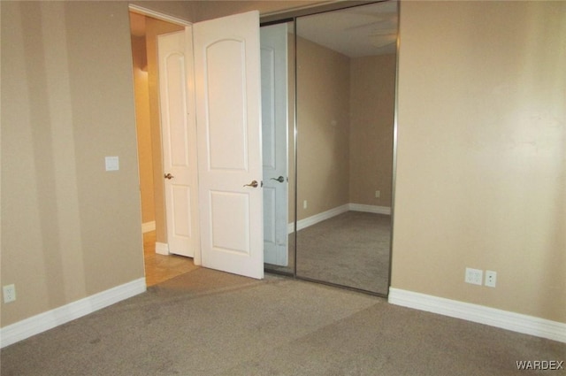 carpeted spare room with baseboards