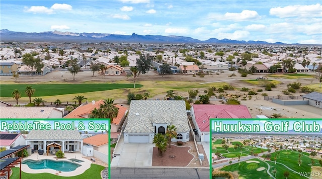 drone / aerial view featuring a residential view, a mountain view, and view of golf course