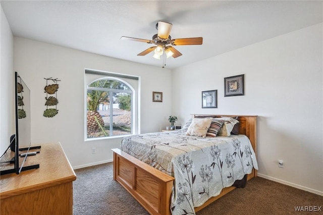 bedroom with ceiling fan, baseboards, and dark colored carpet