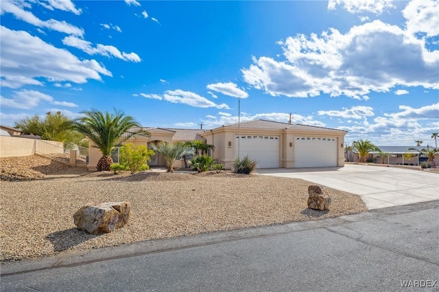 view of front of property featuring a garage, driveway, and stucco siding