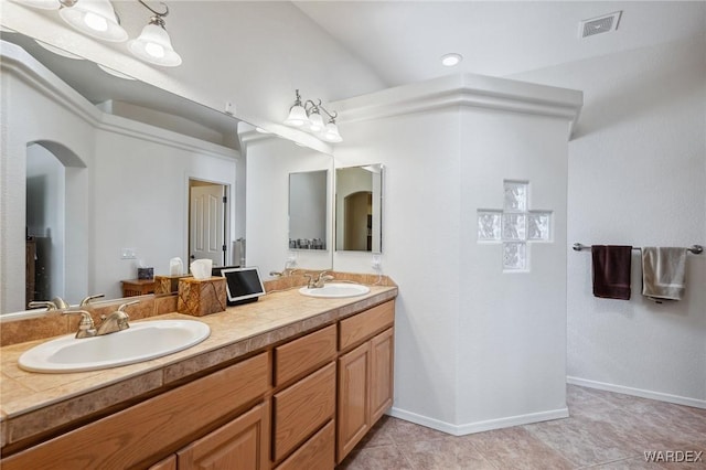 full bath featuring double vanity, tile patterned flooring, a sink, and visible vents