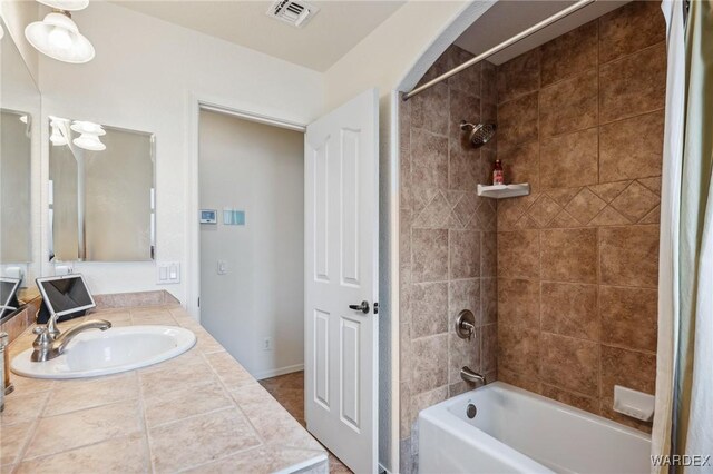 bathroom featuring shower / tub combo, vanity, and visible vents