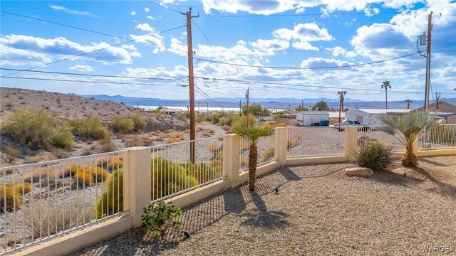 view of yard featuring fence and a mountain view