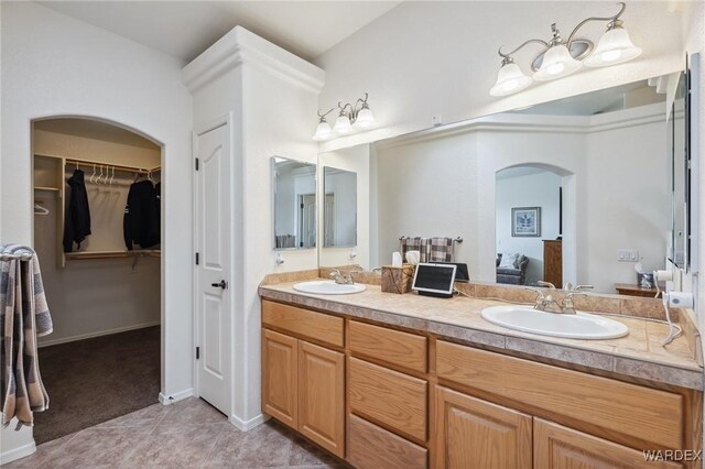 full bathroom featuring double vanity, a sink, ensuite bathroom, and tile patterned floors