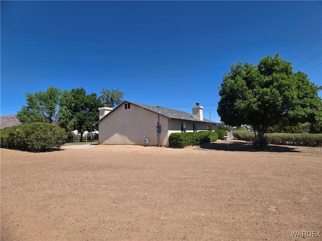 view of side of home with stucco siding