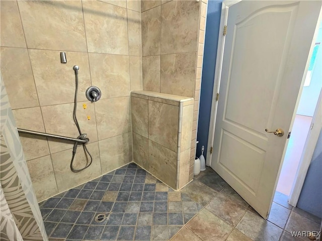 bathroom with a tile shower