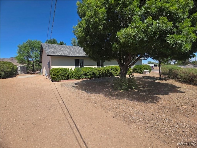 obstructed view of property featuring stucco siding