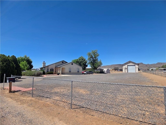 view of yard with a garage, fence, and driveway