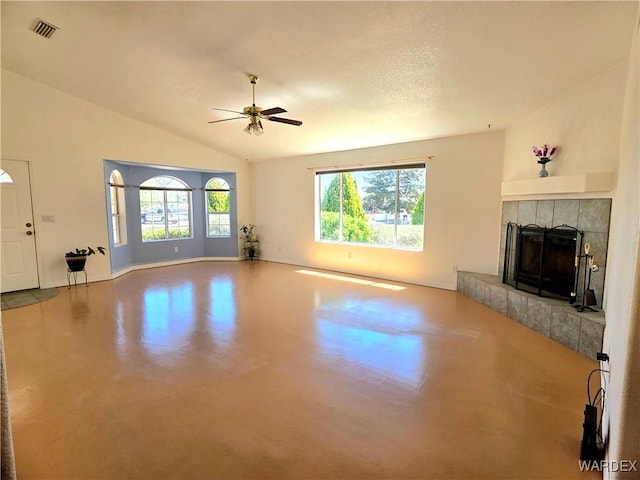 unfurnished living room featuring concrete floors, a tiled fireplace, a ceiling fan, baseboards, and visible vents