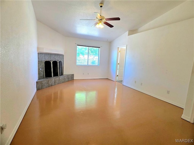 unfurnished living room featuring a fireplace, a ceiling fan, baseboards, finished concrete floors, and vaulted ceiling