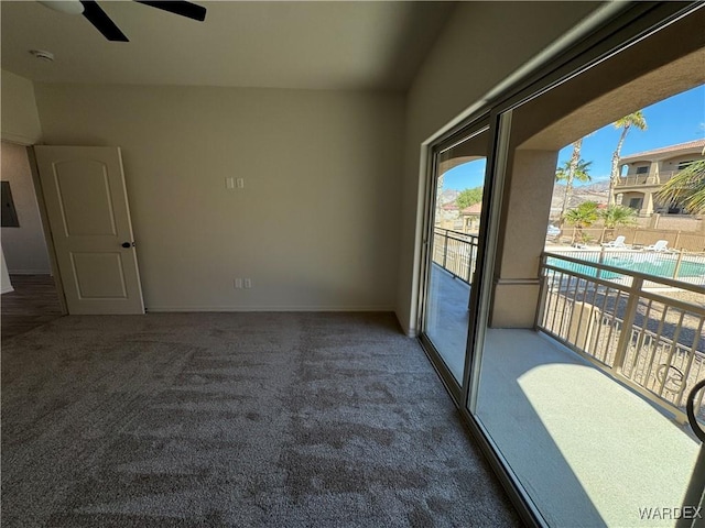 empty room featuring electric panel, dark carpet, and ceiling fan