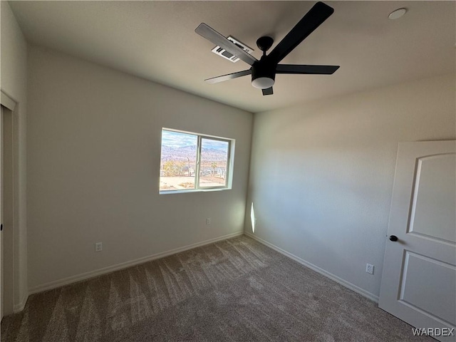 unfurnished room featuring ceiling fan, carpet, visible vents, and baseboards