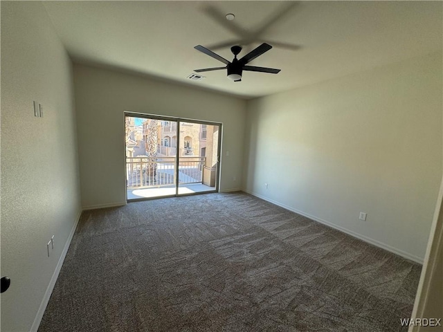 spare room with carpet, visible vents, ceiling fan, and baseboards