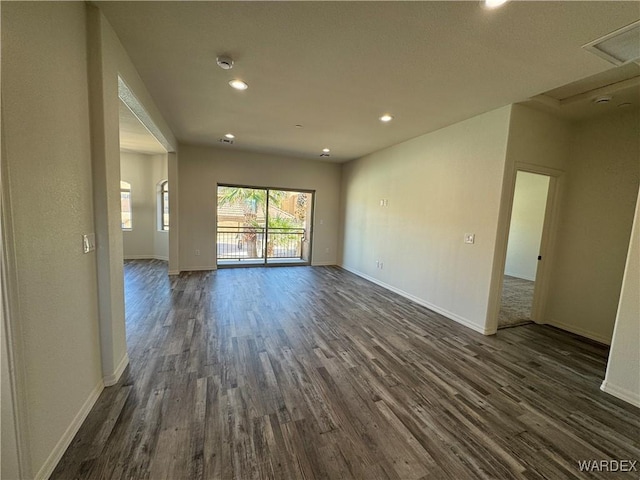 unfurnished room featuring dark wood-type flooring, recessed lighting, and baseboards