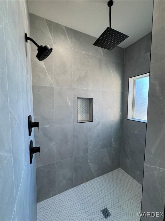 bathroom with tiled shower