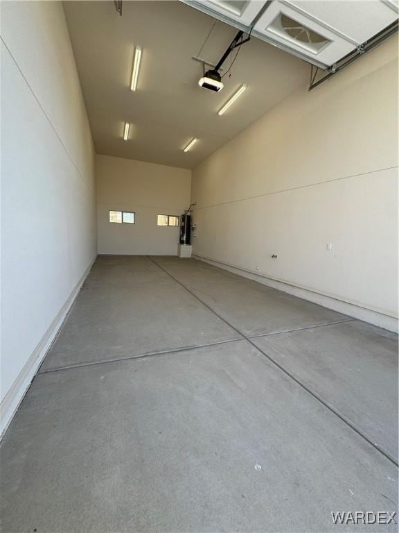 garage with water heater and a garage door opener