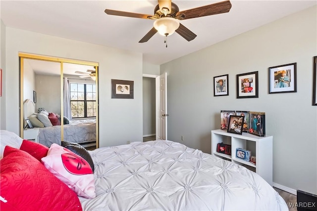 bedroom with ceiling fan, a closet, and baseboards