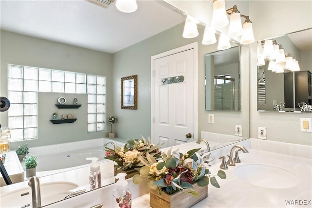 bathroom featuring vanity and a bath