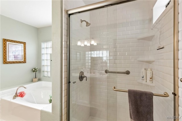 bathroom with a garden tub and a stall shower