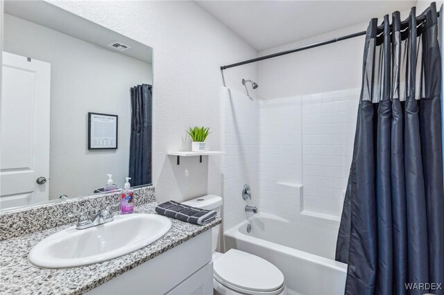 bathroom featuring toilet, shower / tub combo, visible vents, and vanity