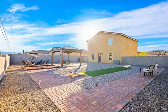 view of patio / terrace featuring central air condition unit, a fenced backyard, and a gazebo