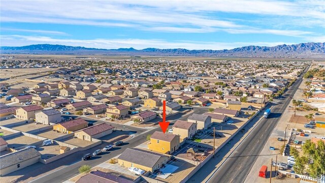 drone / aerial view featuring a residential view and a mountain view