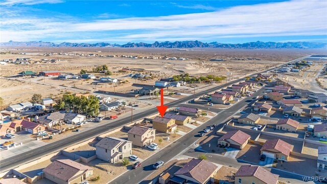 drone / aerial view featuring a residential view and a mountain view