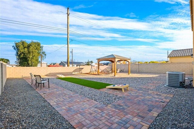 view of playground with a patio area, a fenced backyard, a gazebo, and central AC unit