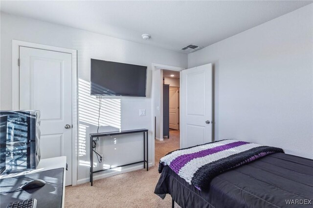 bedroom featuring baseboards, visible vents, and light colored carpet