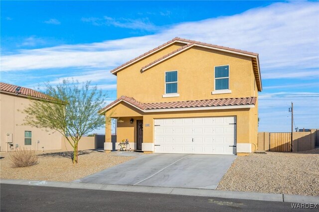 view of front of house with a garage, concrete driveway, a tile roof, fence, and stucco siding