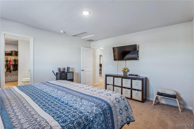 bedroom with attic access, visible vents, baseboards, and light colored carpet