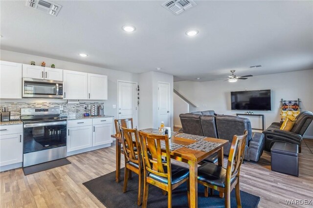 dining space with a ceiling fan, recessed lighting, visible vents, and light wood-style floors