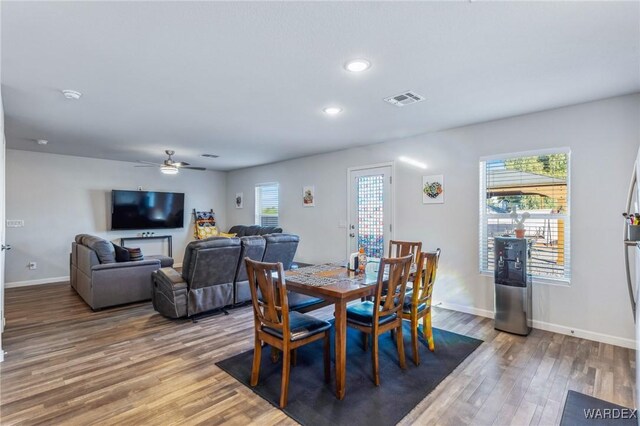 dining space with plenty of natural light, baseboards, wood finished floors, and recessed lighting