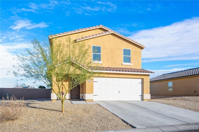 view of front of house featuring a tiled roof, driveway, fence, and stucco siding