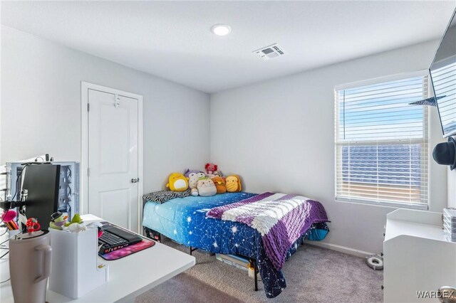 bedroom with carpet floors, baseboards, and visible vents