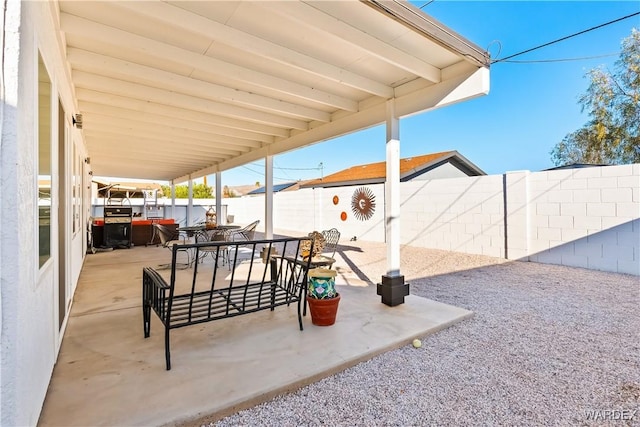 view of patio featuring a fenced backyard and outdoor dining area