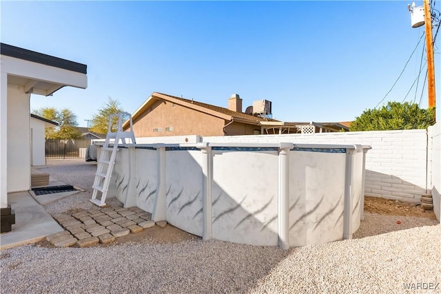 exterior space featuring a fenced backyard and a fenced in pool