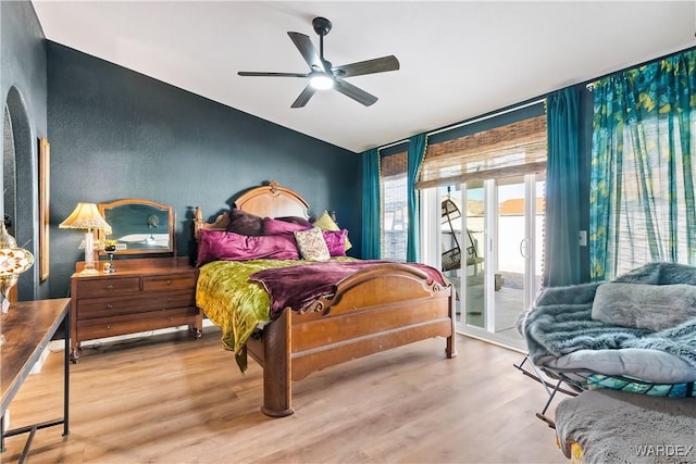 bedroom with access to exterior, ceiling fan, and light wood finished floors