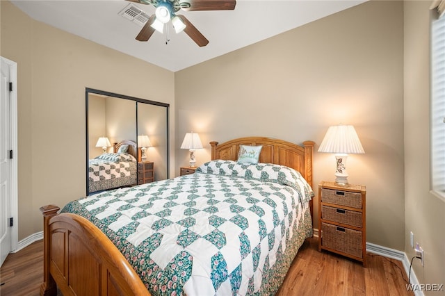 bedroom featuring visible vents, ceiling fan, baseboards, light wood-type flooring, and a closet